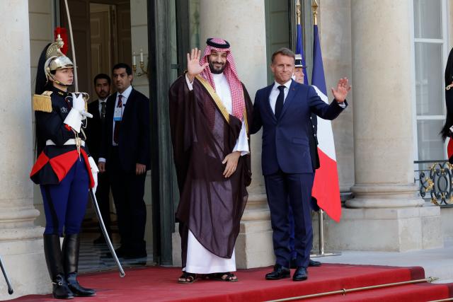 (260824) -- PARIS, Aug. 24, 2026 (Xinhua) -- French President Emmanuel Macron (R) welcomes Saudi Crown Prince and Prime Minister Mohammed bin Salman bin Abdulaziz Al Saud at Elysee Palace, in Paris, France, Aug. 24, 2026. (Photo by Henri Szwarc/Xinhua)