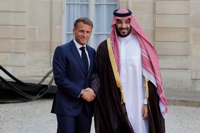 (260824) -- PARIS, Aug. 24, 2026 (Xinhua) -- French President Emmanuel Macron (L) welcomes Saudi Crown Prince and Prime Minister Mohammed bin Salman bin Abdulaziz Al Saud at Elysee Palace, in Paris, France, Aug. 24, 2026. (Photo by Henri Szwarc/Xinhua)