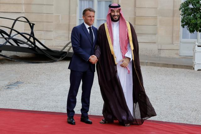 (260824) -- PARIS, Aug. 24, 2026 (Xinhua) -- French President Emmanuel Macron (L) welcomes Saudi Crown Prince and Prime Minister Mohammed bin Salman bin Abdulaziz Al Saud at Elysee Palace, in Paris, France, Aug. 24, 2026. (Photo by Henri Szwarc/Xinhua)