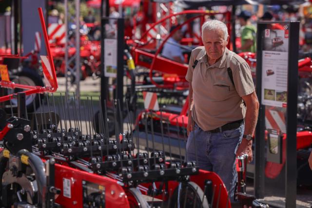 (260824) -- GORNJA RADGONA, Aug. 24, 2026 (Xinhua) -- A visitor observes agricultural machinery on display during the 64th International Fair of Agriculture and Food (AGRA) in Gornja Radgona, northeast Slovenia, Aug. 24, 2026. (Photo by Zeljko Stevanic/Xinhua)