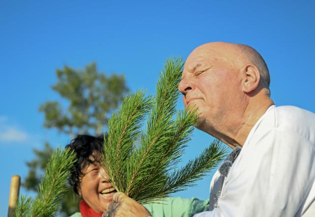 (260825) -- BEIJING, Aug. 25, 2026 (Xinhua) -- Ronald Sakolsky (R) sniffs a sapling after planting it with Yin Yuzhen in the Maowusu Sandy Land in north China's Inner Mongolia Autonomous Region, Aug. 24, 2026. Retired U.S. teacher Ronald Sakolsky revisited the Maowusu Sandy Land on Monday and planted sapling with his friend Yin Yuzhen, a national model worker who has been planting trees here for four decades, as well as Yin's husband Bai Wanxiang.
   Their story began in 1999, when Sakolsky taught English at a school in central China's Henan Province under a teachers' exchange program between the two countries.
   After watching a television news report featuring Yin's tireless work, he was deeply moved and raised 5,000 U.S. dollars to help Yin and her husband in their afforestation efforts against desertification.
   The saplings bought and planted with that donation have since grown into a forest of more than 50,000 towering trees. (Xinhua/Lian Zhen)