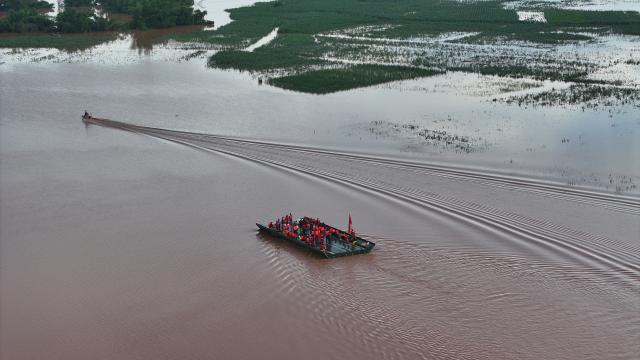 (260825) -- NINGMING, Aug. 25, 2026 (Xinhua) -- An aerial drone photo taken on Aug. 24, 2026 shows a powered pontoon bridge sailing in the flooded area in Beijiang Township, Ningming County, south China's Guangxi Zhuang Autonomous Region. Rescue forces have been deployed in Ningming County where typhoon-triggered heavy rainfall caused flood. A powered pontoon bridge was deployed for emergency rescue operations on Monday. (Xinhua/Zhou Hua)