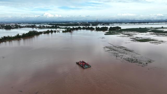 (260825) -- NINGMING, Aug. 25, 2026 (Xinhua) -- An aerial drone photo taken on Aug. 24, 2026 shows a powered pontoon bridge sailing in the flooded area in Beijiang Township, Ningming County, south China's Guangxi Zhuang Autonomous Region. Rescue forces have been deployed in Ningming County where typhoon-triggered heavy rainfall caused flood. A powered pontoon bridge was deployed for emergency rescue operations on Monday. (Xinhua/Zhou Hua)