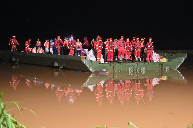 (260825) -- NINGMING, Aug. 25, 2026 (Xinhua) -- A powered pontoon bridge sails in the flooded area in Beijiang Township, Ningming County, south China's Guangxi Zhuang Autonomous Region, Aug. 24, 2026. Rescue forces have been deployed in Ningming County where typhoon-triggered heavy rainfall caused flood. A powered pontoon bridge was deployed for emergency rescue operations on Monday. (Xinhua/Zhou Hua)