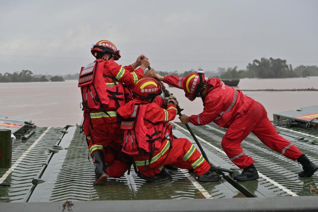 (260825) -- NINGMING, Aug. 25, 2026 (Xinhua) -- Rescuers assemble a powered pontoon bridge in Beijiang Township, Ningming County, south China's Guangxi Zhuang Autonomous Region, Aug. 24, 2026. Rescue forces have been deployed in Ningming County where typhoon-triggered heavy rainfall caused flood. A powered pontoon bridge was deployed for emergency rescue operations on Monday. (Xinhua/Zhou Hua)
