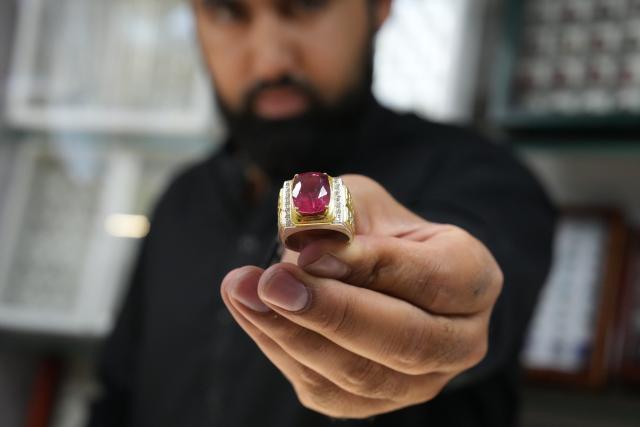 (260825) -- KABUL, Aug. 25, 2026 (Xinhua) -- A vendor displays a ring inlaid with a gemstone at his shop in Kabul, Afghanistan, on Aug. 23, 2026. TO GO WITH "Feature: Afghan gemstones seek new luster through global trade" (Photo by Saifurahman Safi/Xinhua)