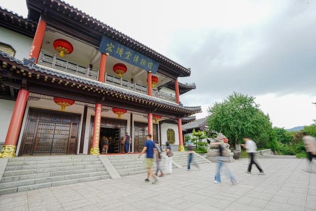 (260825) -- JINAN, Aug. 25, 2026 (Xinhua) -- People visit the Hongjitang Museum in Hongjitang TCM Culture & Tourism Resort in Jinan, east China's Shandong Province, Aug. 24, 2026. Founded in 1907, Shandong Hongjitang Pharmaceutical Group Co., Ltd. adheres to the mission of inheriting the essence of traditional Chinese medicine (TCM) making and popularizing TCM culture. It has built Hongjitang TCM Culture & Tourism Resort which provides educational study tours as well as leisure activities. Visitors can observe TCM production process during sightseeing tours and try on making herbal drinks by themselves in its demonstration halls. (Xinhua/Dai Mingxuan)