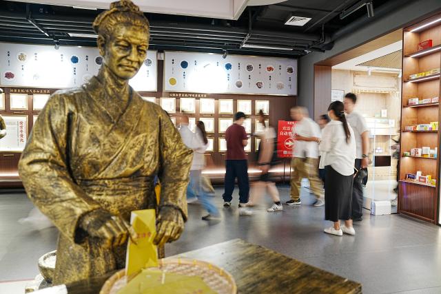 (260825) -- JINAN, Aug. 25, 2026 (Xinhua) -- People visit a medicine museum in Hongjitang TCM Culture & Tourism Resort in Jinan, east China's Shandong Province, Aug. 24, 2026. Founded in 1907, Shandong Hongjitang Pharmaceutical Group Co., Ltd. adheres to the mission of inheriting the essence of traditional Chinese medicine (TCM) making and popularizing TCM culture. It has built Hongjitang TCM Culture & Tourism Resort which provides educational study tours as well as leisure activities. Visitors can observe TCM production process during sightseeing tours and try on making herbal drinks by themselves in its demonstration halls. (Xinhua/Dai Mingxuan)