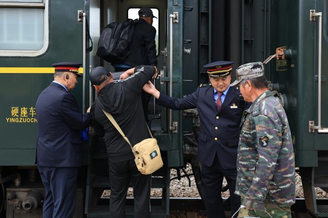 (260825) -- DAXING'ANLING, Aug. 25, 2026 (Xinhua) -- Passengers board the train 6245 at Cuifeng railway station in Daxing'anling area, northeast China's Heilongjiang Province, Aug. 24, 2026. Each August and September, the Daxing'anling area enters its harvest season for mountain produce.
  The train 6245/6 running between Jagdaqi and Gulian in Heilongjiang carries forest gatherers from various places deep into the forest to collect mountain produce. (Photo by Xu Shuai/Xinhua)
