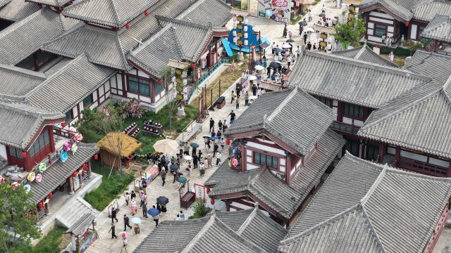 (260827) -- LAOLING, Aug. 27, 2026 (Xinhua) -- An aerial drone photo shows tourists visiting the Laoling Film Studio in Laoling City, east China's Shandong Province, Aug. 25, 2026.
  Laoling Film Studio, with its themed sets such as a 1:1 replica of San Francisco's Chinatown in 1900 and the prosperous Chang'an West Market of the Tang Dynasty (618-907), has become a new landmark for film and a driving force of the film industry on tourism in Shandong Province. More than 50 productions have been filmed here. (Photo by Jia Peng/Xinhua)