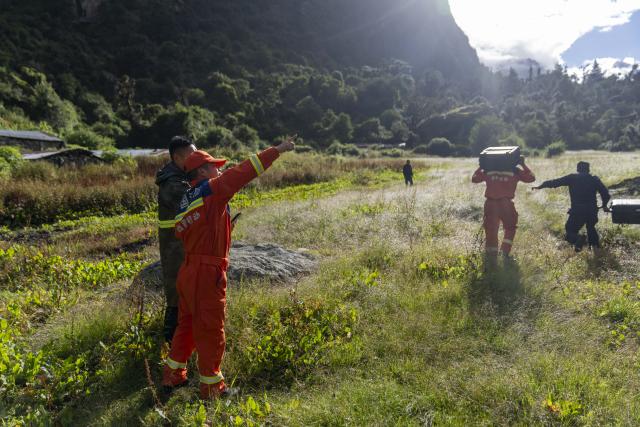 (260827) -- XIGAZE, Aug. 27, 2026 (Xinhua) -- Rescuers prepare to fly a drone to inspect the mudslide-hit areas, in Xigaze, southwest China's Xizang Autonomous Region, Aug. 27, 2026.
  A mudslide, which occurred on the Nepalese side, struck Gyirong Port in Gyirong County of Xigaze City, Xizang, on Wednesday morning, leaving three people dead and 558 others, including 260 foreign nationals, missing, according to preliminary estimates. (Xinhua/Tenzing Nima Qadhup)