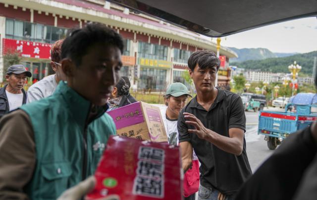 (260827) -- XIGAZE, Aug. 27, 2026 (Xinhua) -- People unload instant noodles from a vehicle in Gyirong Town of Gyirong County, Xigaze City, southwest China's Xizang Autonomous Region, Aug. 27, 2026. Six vehicles loaded with relief supplies, including instant noodles, rice, flour, mineral water and other daily necessities, arrived in Gyirong Town on Thursday afternoon. (Xinhua/Jigme Dorje)