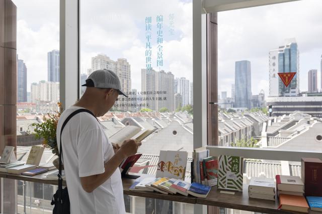 (260827) -- SHANGHAI, Aug. 27, 2026 (Xinhua) -- A visitor reads at the Shanghai Literature Museum in Hongkou District, east China's Shanghai, Aug. 27, 2026. After years of preparation, the Shanghai Literature Museum, a comprehensive literary institution, officially opened to the public on Thursday, offering a concentrated showcase of the evolution and remarkable achievements of Shanghai literature. 
   The museum consists of a main building and three historic buildings, featuring five permanent exhibition zones that reveal the history and character of Shanghai literature from different perspectives. (Xinhua/Wang Xiang)