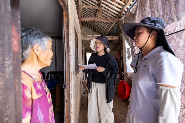 (260827) -- HANGZHOU, Aug. 27, 2026 (Xinhua) -- Local cadres check on a villager at Jiangpai Village in Huzhou City, east China's Zhejiang Province, Aug. 27, 2026. East China's Zhejiang Province raised its typhoon emergency response to Level I, the highest level, at 8 p.m. Thursday as Typhoon Saudel, the 18th typhoon of this year, is forecast to make landfall in the province. (Photo by Yi Fan/Xinhua)