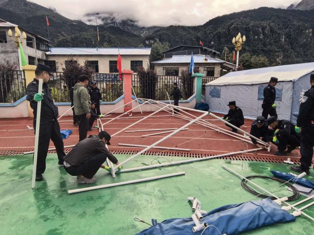 (260827) -- GYIRONG, Aug. 27, 2026 (Xinhua) -- Auxiliary police officers set up tents at a temporary shelter in Gyirong County in Xigaze, southwest China's Xizang Autonomous Region, Aug. 27, 2026. The first batch of 26 rescue officers from the local public security authorities in Gyirong have set up 24 emergency tents in the courtyard of a township government compound and evacuated more than 320 residents affected by a mudslide in Gyirong County. (Xinhua)