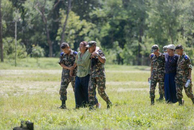 (260827) -- NUWAKOT, Aug. 27, 2026 (Xinhua) -- Soldiers transfer people after a massive flash flood in Nuwakot, Nepal, on Aug. 27, 2026. Nepal's National Disaster Risk Reduction Management Authority said that as many as 359 bodies had been recovered from flood-hit areas by Thursday evening, with 910 people still missing. (Photo by Sulav Shrestha/Xinhua)
