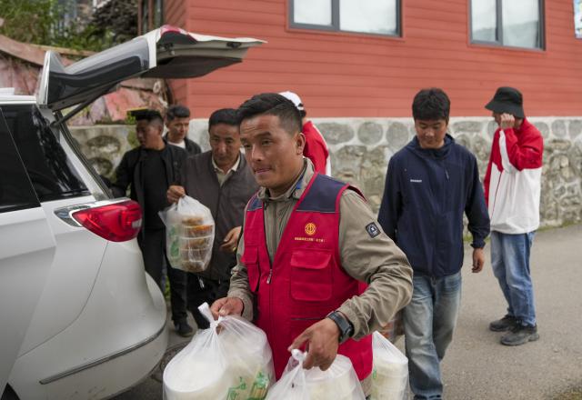 (260827) -- XIGAZE, Aug. 27, 2026 (Xinhua) -- Staff members deliver meals for evacuees in Gyirong County in Xigaze, southwest China's Xizang Autonomous Region, Aug. 27, 2026. Residents affected by a mudslide in Gyirong County, southwest China's Xizang Autonomous Region, have been resettled, and all stranded tourists have been transferred, local authorities said Thursday.
   A total of 499 villagers and construction workers have all been properly accommodated. Meanwhile, 555 affected tourists were evacuated and transferred under the coordination of cultural and tourism authorities. No tourists remain stranded.
   Civil aviation authorities have also joined the rescue efforts. As of 3 p.m. Thursday, civil aviation services had transported 324 rescue personnel and delivered 24 tonnes of rescue equipment, daily necessities and medical supplies to the disaster-hit area, providing support for emergency response and the relocation of affected residents.
   The mudslide struck Gyirong Port in Gyirong County, Xizang, on Wednesday morning. As of 8 a.m. on Thursday, three people had been killed, 558 others remained missing, while two local villagers had been rescued. (Xinhua/Jigme Dorje)
