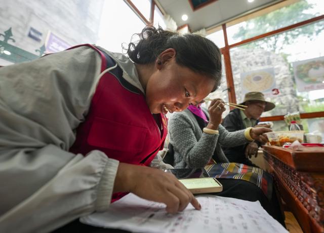 (260827) -- XIGAZE, Aug. 27, 2026 (Xinhua) -- A staff member checks the phone numbers of the evacuees who have just moved to Jifu Village of Gyirong County in Xigaze, southwest China's Xizang Autonomous Region, Aug. 27, 2026. Residents affected by a mudslide in Gyirong County, southwest China's Xizang Autonomous Region, have been resettled, and all stranded tourists have been transferred, local authorities said Thursday.
   A total of 499 villagers and construction workers have all been properly accommodated. Meanwhile, 555 affected tourists were evacuated and transferred under the coordination of cultural and tourism authorities. No tourists remain stranded.
   Civil aviation authorities have also joined the rescue efforts. As of 3 p.m. Thursday, civil aviation services had transported 324 rescue personnel and delivered 24 tonnes of rescue equipment, daily necessities and medical supplies to the disaster-hit area, providing support for emergency response and the relocation of affected residents.
   The mudslide struck Gyirong Port in Gyirong County, Xizang, on Wednesday morning. As of 8 a.m. on Thursday, three people had been killed, 558 others remained missing, while two local villagers had been rescued. (Xinhua/Jigme Dorje)