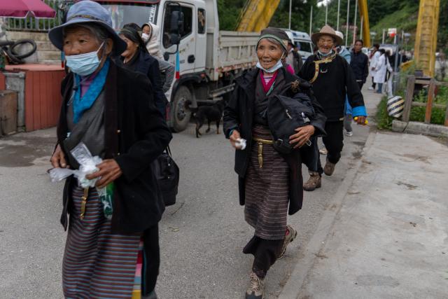 (260827) -- XIGAZE, Aug. 27, 2026 (Xinhua) -- Evacuees from Labi Village head for a hostel in Jifu Village of Gyirong County in Xigaze, southwest China's Xizang Autonomous Region, Aug. 27, 2026. Residents affected by a mudslide in Gyirong County, southwest China's Xizang Autonomous Region, have been resettled, and all stranded tourists have been transferred, local authorities said Thursday.
   A total of 499 villagers and construction workers have all been properly accommodated. Meanwhile, 555 affected tourists were evacuated and transferred under the coordination of cultural and tourism authorities. No tourists remain stranded.
   Civil aviation authorities have also joined the rescue efforts. As of 3 p.m. Thursday, civil aviation services had transported 324 rescue personnel and delivered 24 tonnes of rescue equipment, daily necessities and medical supplies to the disaster-hit area, providing support for emergency response and the relocation of affected residents.
   The mudslide struck Gyirong Port in Gyirong County, Xizang, on Wednesday morning. As of 8 a.m. on Thursday, three people had been killed, 558 others remained missing, while two local villagers had been rescued. (Xinhua/Tenzing Nima Qadhup)
