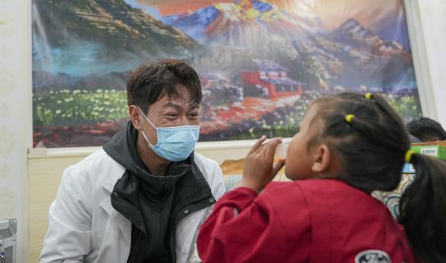 (260827) -- XIGAZE, Aug. 27, 2026 (Xinhua) -- A medical worker helps a resettled girl take medicine in Jifu Village of Gyirong County in Xigaze, southwest China's Xizang Autonomous Region, Aug. 27, 2026. Residents affected by a mudslide in Gyirong County, southwest China's Xizang Autonomous Region, have been resettled, and all stranded tourists have been transferred, local authorities said Thursday.
   A total of 499 villagers and construction workers have all been properly accommodated. Meanwhile, 555 affected tourists were evacuated and transferred under the coordination of cultural and tourism authorities. No tourists remain stranded.
   Civil aviation authorities have also joined the rescue efforts. As of 3 p.m. Thursday, civil aviation services had transported 324 rescue personnel and delivered 24 tonnes of rescue equipment, daily necessities and medical supplies to the disaster-hit area, providing support for emergency response and the relocation of affected residents.
   The mudslide struck Gyirong Port in Gyirong County, Xizang, on Wednesday morning. As of 8 a.m. on Thursday, three people had been killed, 558 others remained missing, while two local villagers had been rescued. (Xinhua/Jigme Dorje)