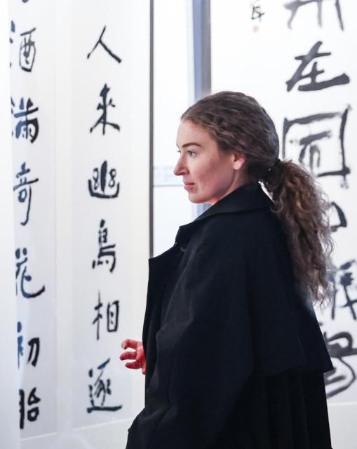 (260827) -- WELLINGTON, Aug. 27, 2026 (Xinhua) -- A visitor views Chinese calligraphy works on display at the opening ceremony of an international art dialogue exhibition by China National Academy of Painting in Wellington, New Zealand, Aug. 27, 2026. An international art dialogue exhibition by China National Academy of Painting kicked off in the New Zealand capital on Thursday in celebration of the 20th anniversary of sister city relations between Wellington and Beijing. (Xinhua/Long Lei)