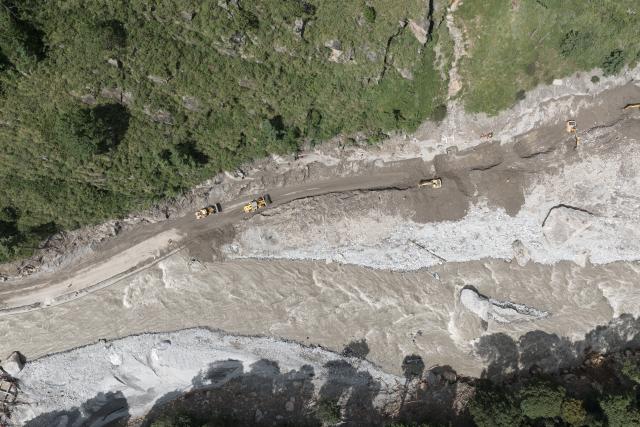 (260828) -- GYIRONG, Aug. 28, 2026 (Xinhua) -- An aerial photo taken on Aug. 28, 2026 shows rescuers restoring a damaged road at the mudslide-hit areas in Gyirong, southwest China's Xizang Autonomous Region. Rescuers and engineering machines are operating around the clock to repair the mudslide-damaged road that leads to the Gyirong Port. (Xinhua/Jiang Fan)