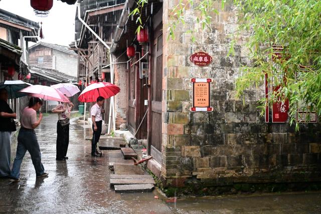 (260828) -- SANMING, Aug. 28, 2026 (Xinhua) -- Local officials patrol in Fukou Village of Fukou Town, Sanming City, southeast China's Fujian Province, Aug. 28, 2026. Torrential rains caused by typhoon Saudel are forecast for central and northern parts of Fujian Province from Friday to Saturday. A series of preventive measures have been taken to ensure public safety. (Xinhua/Lin Shanchuan)