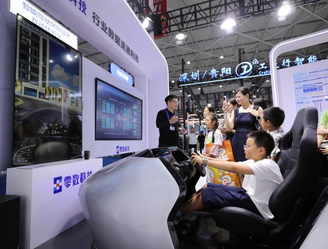 (260828) -- GUIYANG, Aug. 28, 2026 (Xinhua) -- Children experience smart mobility technology during the professional exhibition of the 2026 China International Big Data Industry Expo in Guiyang, southwest China's Guizhou Province, Aug. 28, 2026. Themed "Token: A New Path to Value of Data Elements," the expo spotlights cutting-edge innovations integrating data with artificial intelligence. (Xinhua/Li Xulun)