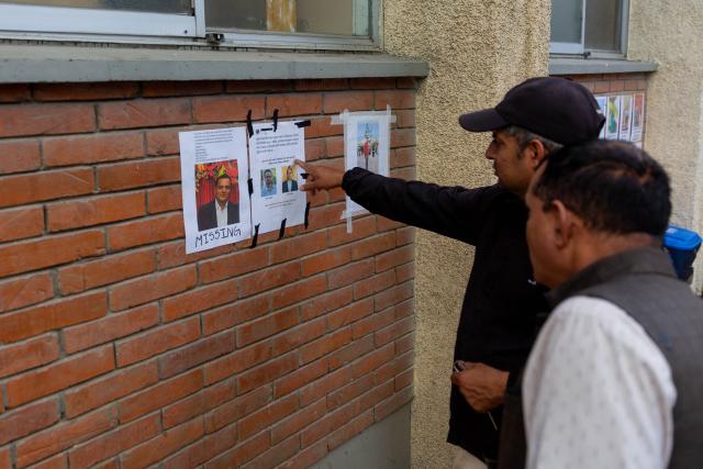 (260828) -- KATHMANDU, Aug. 28, 2026 (Xinhua) -- People look at photos of missing people of a massive flood outside a hospital in Kathmandu, Nepal, on Aug. 28, 2026. The National Disaster Risk Reduction and Management Authority said 579 bodies have been recovered, while 1,924 people are out of contact as of Friday evening. (Photo by Sulav Shrestha/Xinhua)