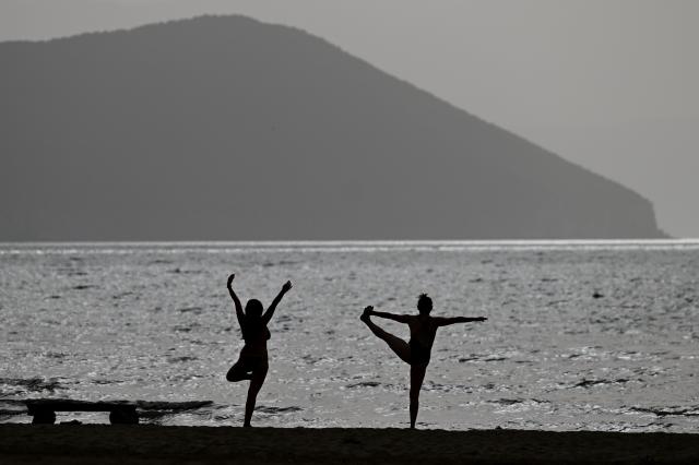 (260828) -- RESEN, Aug. 28, 2026 (Xinhua) -- Two women practice yoga at the shore of Prespa Lake, Resen, North Macedonia, Aug. 28, 2026. Temperatures soar as a heatwave grips the region, with hot summer conditions prevailing across the area. (Photo by Tomislav Georgiev/Xinhua)