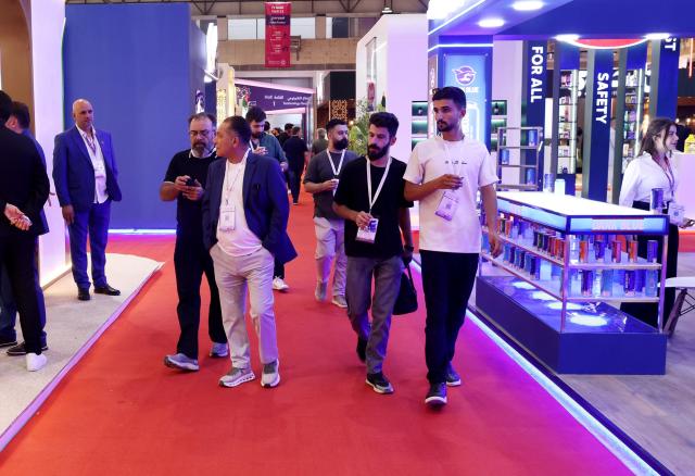 (260828) -- DAMASCUS, Aug. 28, 2026 (Xinhua) -- Visitors walk past exhibition booths at the 63rd Damascus International Fair in Damascus, Syria, Aug. 27, 2026. At an international fair being held in the Syrian capital Damascus, foreign companies are testing the waters of a reconstruction market whose needs are immense, while banking, logistical and institutional hurdles remain. TO GO WITH "Roundup: At Damascus fair, foreign companies test waters of Syria's reconstruction market" (Photo by Ammar Safarjalani/Xinhua)