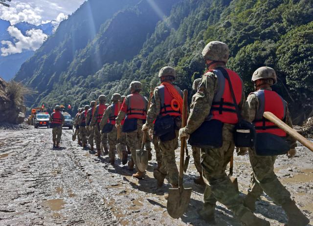 (260829) -- BEIJING, Aug. 29, 2026 (Xinhua) -- Rescuers from the Chinese People's Liberation Army are pictured on their way to the mudslide-hit area near Gyirong Port in Gyirong County, in Xigaze, southwest China's Xizang Autonomous Region, Aug. 28, 2026. Seven people had been killed, and 554 others remained missing, while two local villagers had been rescued as of 1 a.m. on Saturday after a mudslide struck the Gyirong Port along the China-Nepal border in southwest China's Xizang Autonomous Region, according to the region's emergency management department.
   A total of 2,141 rescue workers and 86 specialists from natural resources and other relevant fields have been deployed to the disaster area. With specialized equipment, they have stepped up inspections for geological hazards across surrounding slopes, roads and other critical zones. (Photo by Zheng Chongxi/Xinhua)