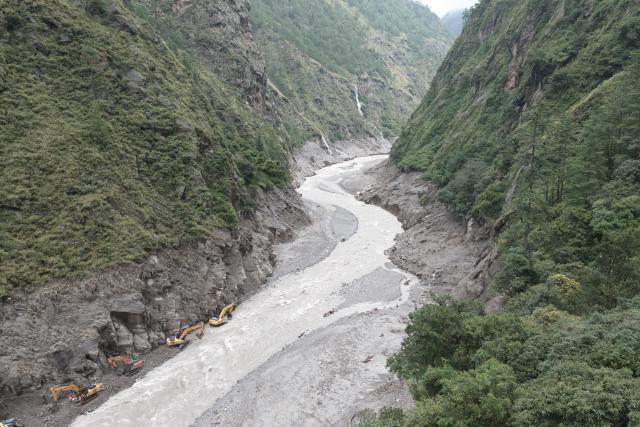 (260829) -- GYIRONG, Aug. 29, 2026 (Xinhua) -- An aerial drone photo shows road clearance operations underway at a section of national highway G216 in Gyirong County, southwest China's Xizang Autonomous Region, on Aug. 29, 2026. A total of 60 technicians along with 14 sets of rescue equipment from China Anneng, a state-owned engineering and rescue enterprise, have been deployed in the road clearance operations on the mudslide-hit section of national highway G216 leading to the Gyirong Port. (Xinhua/Jiang Fan)