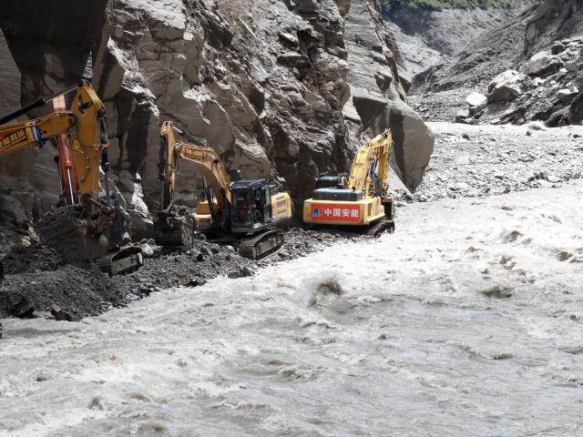 (260829) -- GYIRONG, Aug. 29, 2026 (Xinhua) -- This photo shows road clearance operations underway at a section of national highway G216 in Gyirong County, southwest China's Xizang Autonomous Region, on Aug. 29, 2026. A total of 60 technicians along with 14 sets of rescue equipment from China Anneng, a state-owned engineering and rescue enterprise, have been deployed in the road clearance operations on the mudslide-hit section of national highway G216 leading to the Gyirong Port. (Xinhua/Jiang Fan)