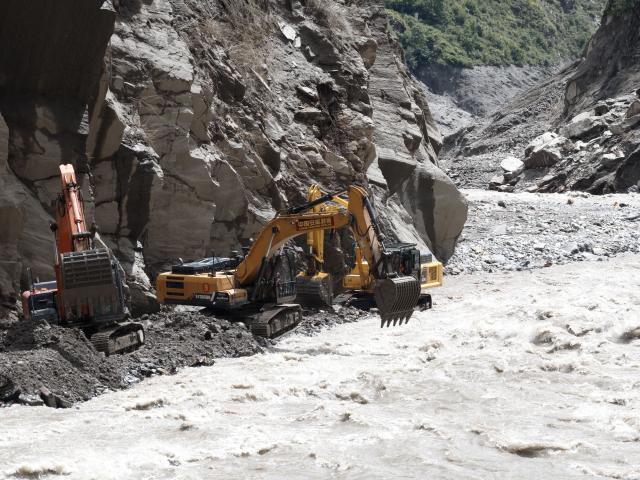(260829) -- GYIRONG, Aug. 29, 2026 (Xinhua) -- This photo shows road clearance operations underway at a section of national highway G216 in Gyirong County, southwest China's Xizang Autonomous Region, on Aug. 29, 2026. A total of 60 technicians along with 14 sets of rescue equipment from China Anneng, a state-owned engineering and rescue enterprise, have been deployed in the road clearance operations on the mudslide-hit section of national highway G216 leading to the Gyirong Port. (Xinhua/Tenzing Nima Qadhup)