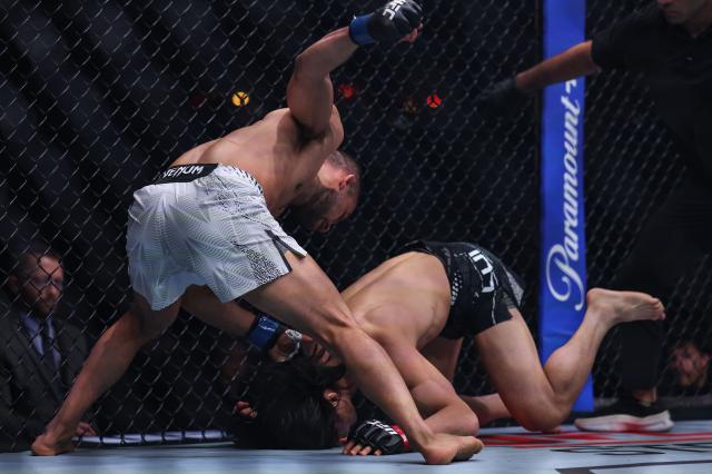 (260829) -- SHANGHAI, Aug. 29, 2026 (Xinhua) -- Hector Santiago (L) of Brazil competes against Lawrence Lui of New Zealand during the UFC Fight Night Bantamweight Bout 3 Rounds at the Oriental Sports Center in east China's Shanghai, Aug. 29, 2026. (Xinhua/Li Ming)