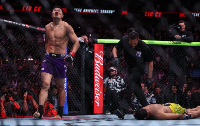 (260829) -- SHANGHAI, Aug. 29, 2026 (Xinhua) -- Liu Ce (L) of China celebrates after defeating Levi Rodrigues Jr. of Brazil during the UFC Fight Night Light Heavyweight Bout 3 Rounds at the Oriental Sports Center in east China's Shanghai, Aug. 29, 2026. (Xinhua/Li Ming)