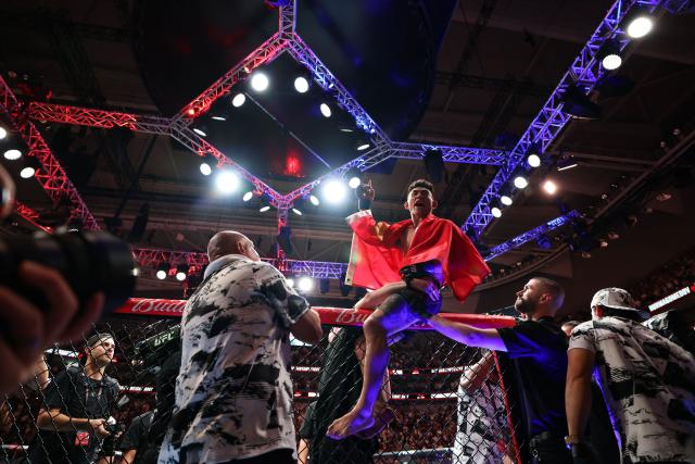 (260829) -- SHANGHAI, Aug. 29, 2026 (Xinhua) -- Song Yadong (top) of China celebrates after winng the UFC Fight Night Bantamweight Bout (Main Event) 5 Rounds against Umar Nurmagomedov of Russia at the Oriental Sports Center in east China's Shanghai, Aug. 29, 2026. (Xinhua/Li Ming)