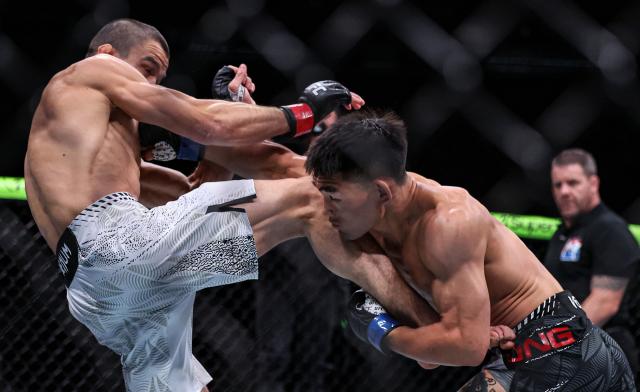 (260829) -- SHANGHAI, Aug. 29, 2026 (Xinhua) -- Song Yadong (front R) of China competes against Umar Nurmagomedov of Russia during the UFC Fight Night Bantamweight Bout (Main Event) 5 Rounds at the Oriental Sports Center in east China's Shanghai, Aug. 29, 2026. (Xinhua/Li Ming)