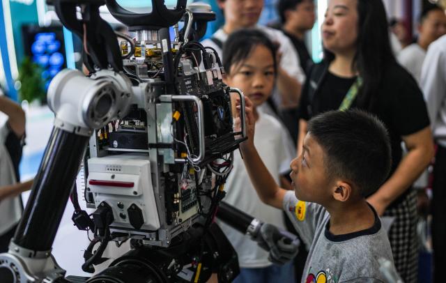 (260829) -- GUIYANG, Aug. 29, 2026 (Xinhua) -- A boy learns about the internal structure of a robot with its covering parts removed at the 2026 China International Big Data Industry Expo in Guiyang, southwest China's Guizhou Province, Aug. 28, 2026. The expo kicked off here on Friday, showcasing the cutting-edge technologies in several key sectors including computing power infrastructure, data supply, model-driven innovation, security safeguards, and intelligent experiences. (Xinhua/Tao Liang)
