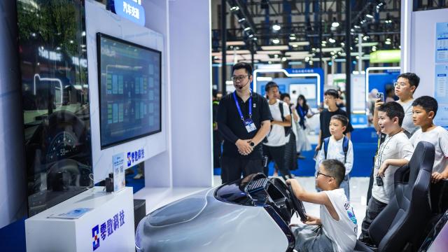 (260829) -- GUIYANG, Aug. 29, 2026 (Xinhua) -- Children get hands-on experience with a smart driving simulator at the 2026 China International Big Data Industry Expo in Guiyang, southwest China's Guizhou Province, Aug. 28, 2026. The expo kicked off here on Friday, showcasing the cutting-edge technologies in several key sectors including computing power infrastructure, data supply, model-driven innovation, security safeguards, and intelligent experiences. (Xinhua/Tao Liang)
