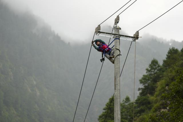 (260829) -- GYIRONG, Aug. 29, 2026 (Xinhua) -- A staff member check power cables near mudslide-hit Gyirong Port in Gyirong County, southwest China's Xizang Autonomous Region, Aug. 29, 2026. Staff members of the local power company has set up an emergency power transformer not far from the mudslide-hit Gyirong Port, as part of their efforts to ensure power supply for all rescue operations. Power supply is gradually restored in the mudslide-hit areas. (Xinhua/Jigme Dorje)