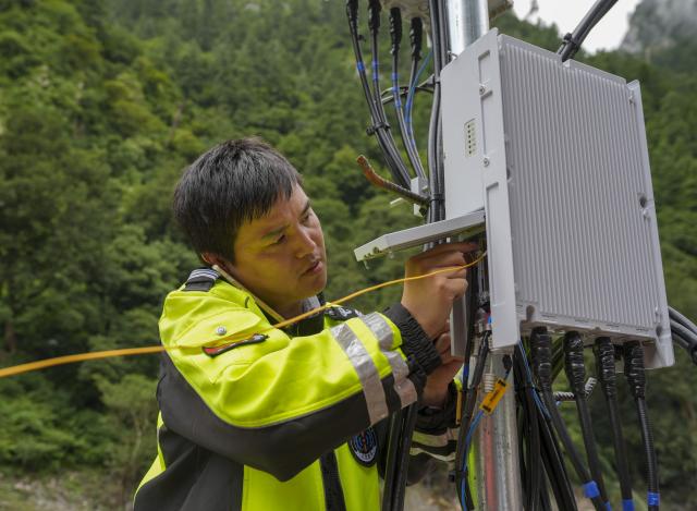 (260829) -- GYIRONG, Aug. 29, 2026 (Xinhua) -- A staff member works on a base station in Gyirong Town, southwest China's Xizang Autonomous Region, Aug. 29, 2026. The telecommunication sector has been making all-out efforts to restore the communication infrastructure affected by the mudslide in Gyirong, and to ensure unimpeded emergency communications. So far, one base station has been restored, and 3 new base stations have been built. (Xinhua/Jigme Dorje)