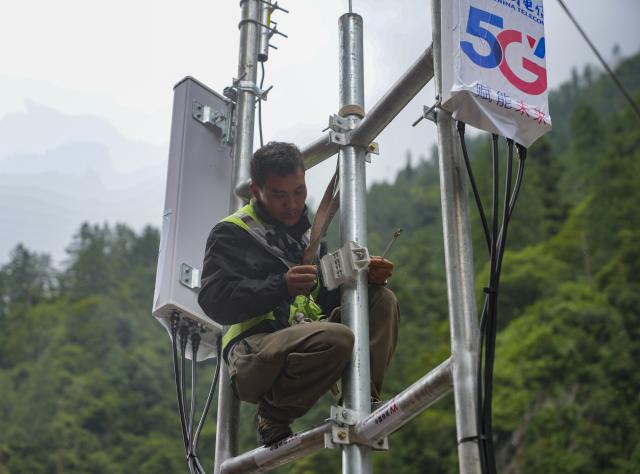 (260829) -- GYIRONG, Aug. 29, 2026 (Xinhua) -- A staff member works on a signal base station in Gyirong Town, southwest China's Xizang Autonomous Region, Aug. 29, 2026. The telecommunication sector has been making all-out efforts to restore the communication infrastructure affected by the mudslide in Gyirong, and to ensure unimpeded emergency communications. So far, one base station has been restored, and 3 new base stations have been built. (Xinhua/Jigme Dorje)