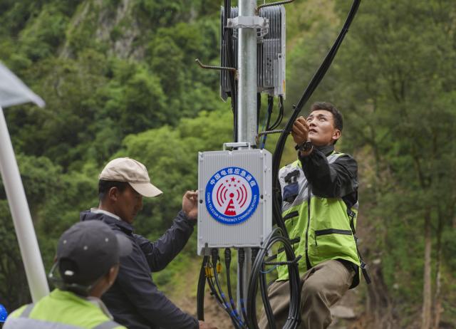 (260829) -- GYIRONG, Aug. 29, 2026 (Xinhua) -- Staff members work on a signal base station in Gyirong Town, southwest China's Xizang Autonomous Region, Aug. 29, 2026. The telecommunication sector has been making all-out efforts to restore the communication infrastructure affected by the mudslide in Gyirong, and to ensure unimpeded emergency communications. So far, one base station has been restored, and 3 new base stations have been built. (Xinhua/Jigme Dorje)
