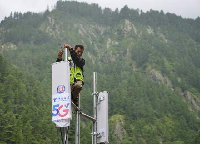 (260829) -- GYIRONG, Aug. 29, 2026 (Xinhua) -- A staff member works on a signal base station in Gyirong Town, southwest China's Xizang Autonomous Region, Aug. 29, 2026. The telecommunication sector has been making all-out efforts to restore the communication infrastructure affected by the mudslide in Gyirong, and to ensure unimpeded emergency communications. So far, one base station has been restored, and 3 new base stations have been built. (Xinhua/Jigme Dorje)