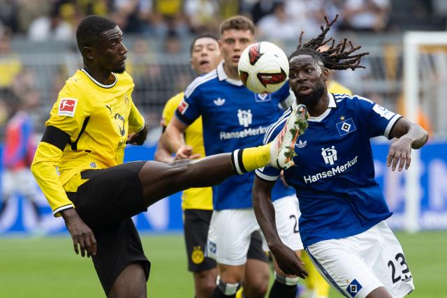 (260830) -- DORTMUND, Aug. 30, 2026 (Xinhua) -- Serhou Guirassy (L) of Borussia Dortmund vies with Jordan Torunarigha of Hamburger SV during the German first division Bundesliga football match between Borussia Dortmund and Hamburger SV in Dortmund, Germany, Aug. 29, 2026. (Photo by Joachim Bywaletz/Xinhua)