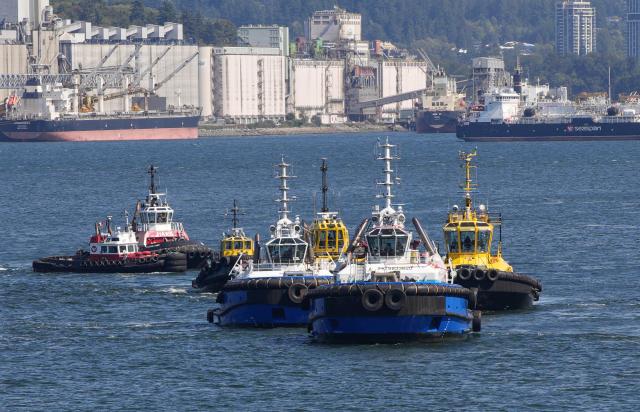 (260830) -- VANCOUVER, Aug. 30, 2026 (Xinhua) -- Tugboats take part in a marine demonstration during the Port Day event in Vancouver, British Columbia, Canada, Aug. 29, 2026. The annual event showcased the local maritime industry and its role in moving Canadian trade, featuring marine demonstrations and interactive exhibits that allowed the public to learn about local port operations and safety practices. (Photo by Liang Sen/Xinhua)