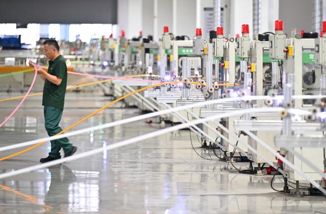 (260830) -- BEIJING, Aug. 30, 2026 (Xinhua) -- A worker works at a smart workshop of a building materials company in north China's Tianjin Municipality, Aug. 28, 2026. In recent years, Beichen District in Tianjin has leveraged technological innovation to upgrade its industries, developing 60 smart factories across sectors including light manufacturing, new materials and high-end equipment. (Xinhua/Li Ran)