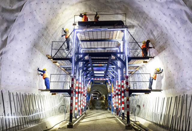 (260830) -- BISHKEK, Aug. 30, 2026 (Xinhua) -- Chinese construction workers are pictured in the Jalalabad tunnel of the China-Kyrgyzstan-Uzbekistan railway in Jalalabad, Kyrgyzstan, Feb. 13, 2026. The China-Kyrgyzstan-Uzbekistan railway is a flagship project of the Belt and Road Initiative, personally promoted by the heads of state of China, Kyrgyzstan and Uzbekistan.
  The route begins in Kashgar, located in northwest China's Xinjiang Uygur Autonomous Region, and passes through the mountainous terrain of Kyrgyzstan to reach Uzbekistan.
  It has become a strategic corridor benefiting all the three countries and their peoples, contributing to regional economic and social development and playing a significant role in promoting infrastructure connectivity, economic and trade exchanges, and high-quality development of the Belt and Road. (Photo by Ren Weiyun/Xinhua)